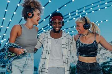 Friends listening music and walking at silent disco event