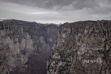snowy mountain peak in winter under the grey clouds