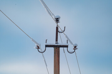 Telegraph pole with wires on the background of blue sky, landscape