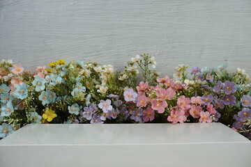 White podium display scene stage showcase front view with copy space and flowers decoration