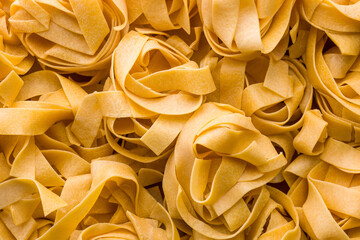 Italian pasta tagliatelle. Uncooked noodle pasta