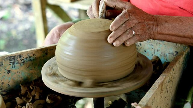 Hands of an old woman potter at work