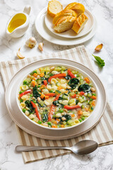 Vegetarian Minestrone with in white bowl, top view