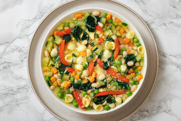 Vegetarian Minestrone with in white bowl, top view