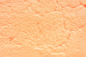 Textured Orange Painted Wall Surface Close-Up
Detailed close-up of a rough orange wall with visible paint texture and surface cracks, suitable for background or design use.
