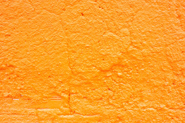 Textured Orange Painted Wall Surface Close-Up
Detailed close-up of a rough orange wall with visible paint texture and surface cracks, suitable for background or design use.
