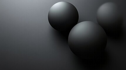 Three matte black spheres rest on a dark gray background