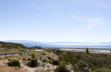 Landscape with Lake Argentino in the distance as a backdrop - winding road on the left side