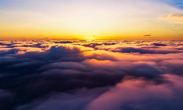 Time lapse of beautiful sky scenery with clouds at sunset. Aerial view of the clouds above the sky with the golden rays of the sun.