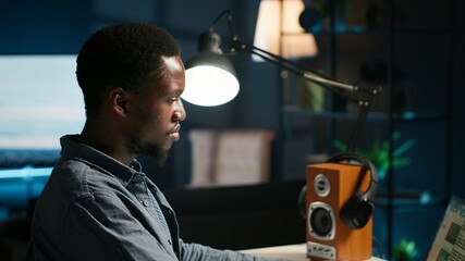 Frustrated african american worker suffers from exhaustion as he works from home, oversees business...