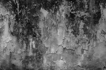 Dark, weathered concrete surface with rough textures and organic patterns, evoking a sense of decay...