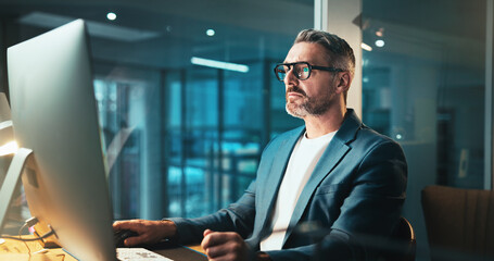 Man, programmer and glasses on computer at night for programming website, software update or...