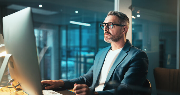 Man, programmer and glasses on computer at night for programming website, software update or deadline. Mature person, online and it with research for problem solving, system error and upgrade process