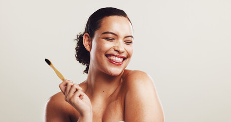 Happy woman, bamboo and toothbrush with dental hygiene in studio for morning routine on a white background. Female person, young model or smile with teeth for oral, mouth or gum care on mockup space