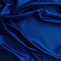 Obraz premium Beautiful dark blue silk satin background. Soft folds on shiny fabric. Luxury background with space for design. Web banner. Flat lay, Table top view. Christmas, Valentine's Day.