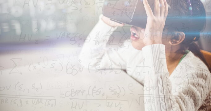 Image of mathematical equations over schoolgirl wearing vr goggles - Powered by Adobe