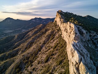Fototapeta premium Mountain ridge at dawn with dramatic shadows and negative space on right