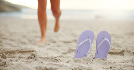 Person, feet or slippers with beach sand for walk, summer fun or outdoor vacation in nature....