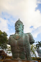 Fototapeta premium Half-body statue of Vishnu in the Garuda Wisnu Kencana complex in Bali Indonesia. In Hinduism, Vishnu is a god who is titled as shtiti, the maintainer of God's creation.