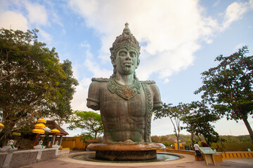 Fototapeta premium Half-body statue of Vishnu in the Garuda Wisnu Kencana complex in Bali Indonesia. In Hinduism, Vishnu is a god who is titled as shtiti, the maintainer of God's creation.