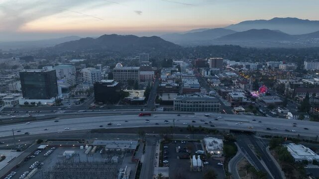 Riverside, California, USA - December 31, 204: A train pulls into the Downtown Train Station and traffic passes on the 91 freeway.
