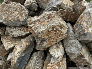 Piles of Weathered Natural Rocks Forming Rugged Textures and Earthy Patterns in Natural Setting