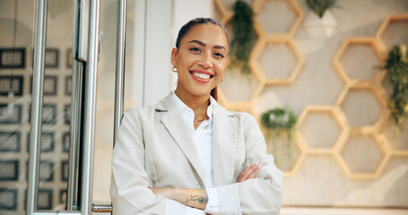 Arms crossed, portrait and smile of woman concierge in hotel for accommodation or welcome. Booking,...