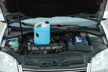 Antifreeze in plastic canister under hood of car