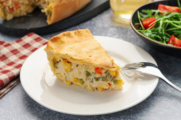 Piece of delicious fresh homemade pie served on gray textured table, closeup