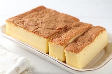 Tasty Japanese Castella sponge cake on white table, closeup