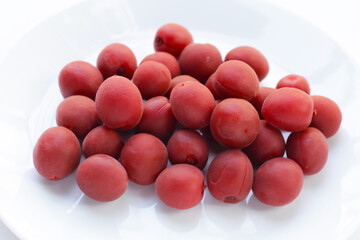 Umeboshi, Japanese pickled plums, Sour and salty taste.