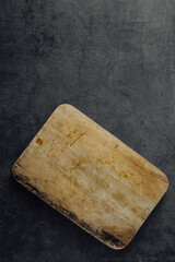 Wooden Cutting Board on Dark Gray Surface with Texture and Natural Grain Patterns