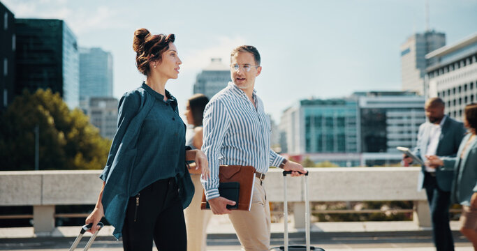 City, meeting and business people with suitcase walking for travel, work trip and commute to conference. Professional, corporate and man and woman with luggage for seminar, discussion and convention