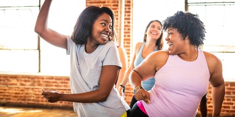 Group of diverse women dancing joyfully in a studio. Diverse women enjoying dance, smiling, and...