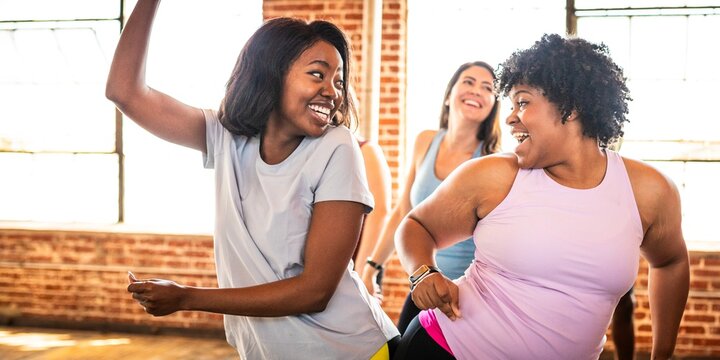 Group of diverse women dancing joyfully in a studio. Diverse women enjoying dance, smiling, and having fun. Dance and joy fill the studio with diverse women. Happy diverse women enjoying dance class. - Powered by Adobe