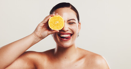 Happy woman, orange and citrus with vitamin c for skincare, detox or nutrition on a white studio background. Female person, model or smile with natural organic fruit for health or anti aging skin