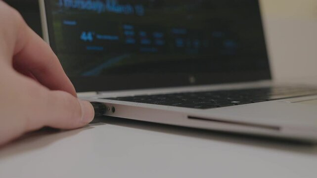 Issaquah WA USA - March 13th 2025: Inserting a USB drive into a laptop for data transfer, storage, or backup.