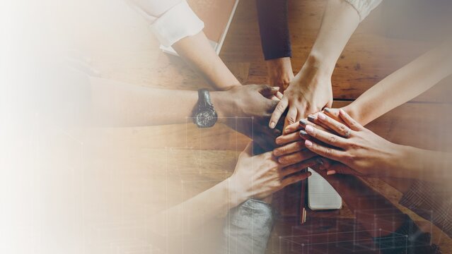 Hands joined over wooden table