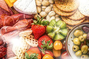 Charcuterie board with cold cuts, fresh fruits and cheese