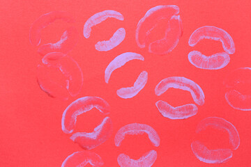 Lilac lipstick kiss marks on red background