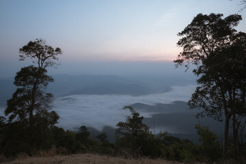 A viewpoint on a high mountain peak with morning fog.