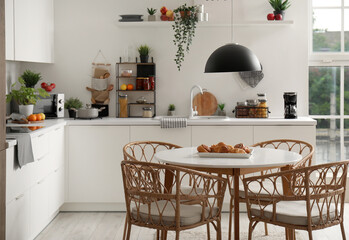 Interior of modern kitchen with wooden dining table