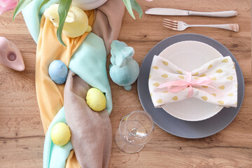 Beautiful Easter table setting with flowers, cutlery and painted eggs