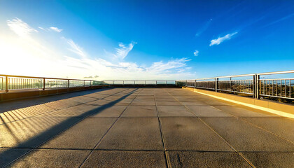 Obraz premium A sunny school rooftop. A large rooftop. A view of the rooftop with concrete, railings and blue sky.