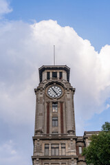 The bell tower of Shanghai History Museum under the blue sky and white clouds