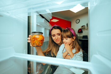 Mother and Daughter Find One Last Jar of Food in the Fridge . Mom forgetting to re stock the...