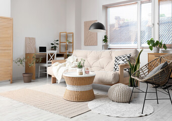 Interior of beautiful living room with comfortable sofa, coffee table and armchair