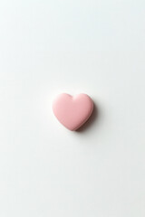 Obraz premium Soft pink heart on a minimalist white background creates a calming visual effect