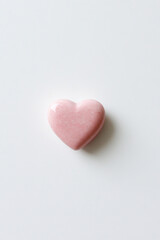 Fototapeta premium Elegant pink heart on a soft white background