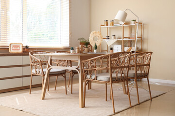 Interior of cozy dining room with wooden table and shelf unit